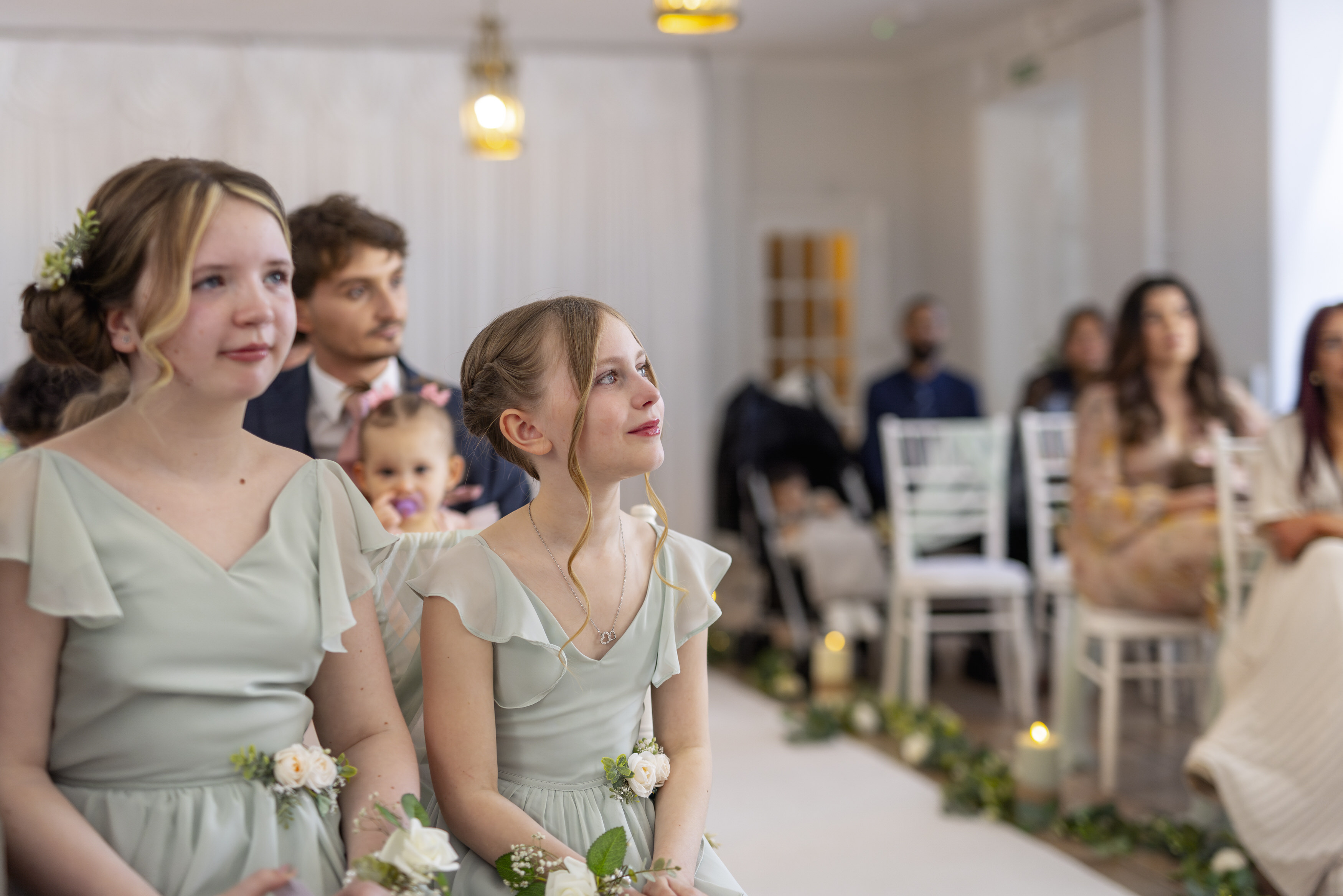 The bridesmaids watching their mother get married 