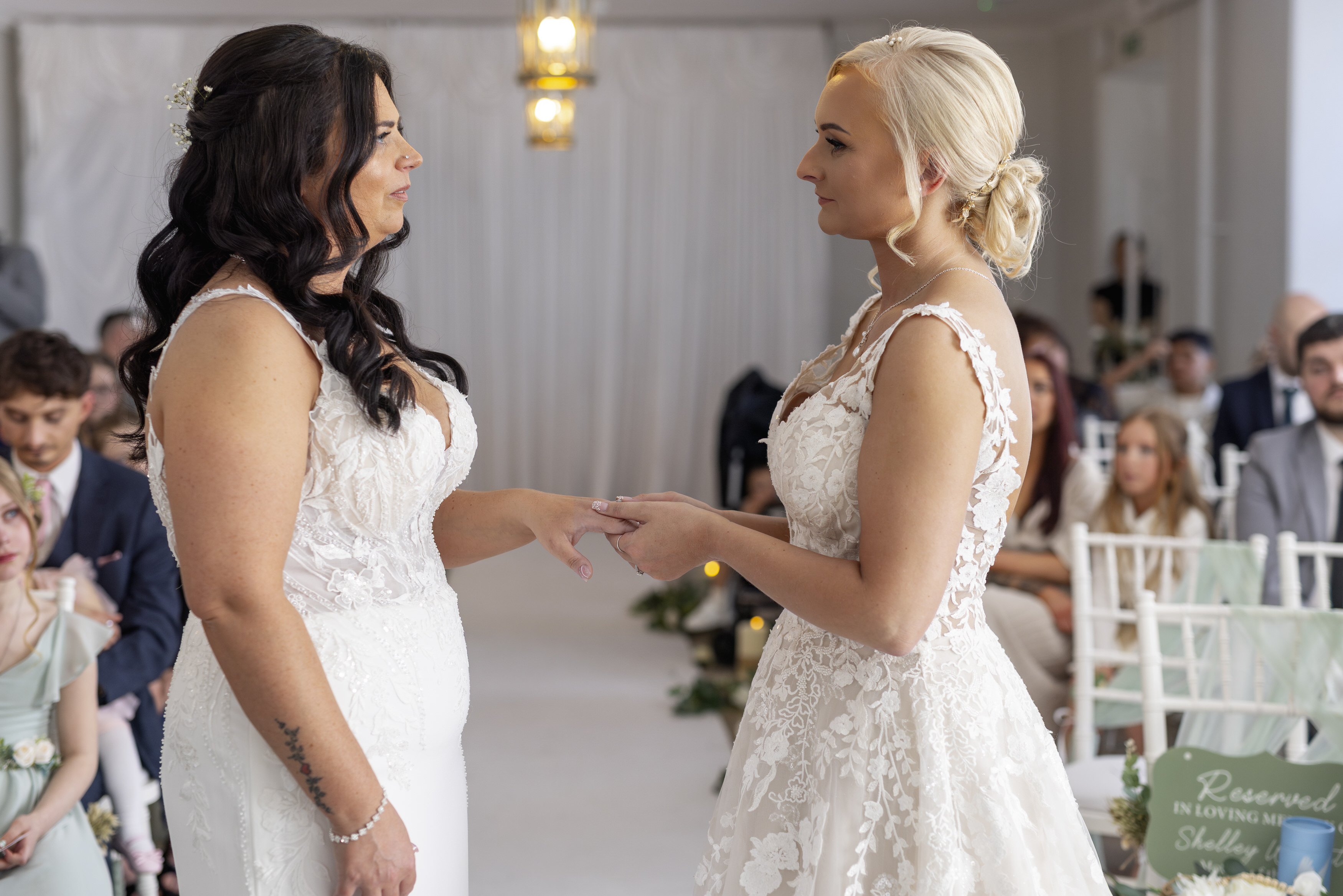 The bride and bride exchange wedding rings 